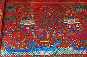 Wat Xieng Thong temple in Luang Prabang, Laos. The red walls decorated with glass mosaics of the Royal Funerary carriage hall. 